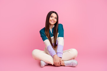 Charming Young positive lovely girl in trendy casual clothes posing on a vibrant pink background