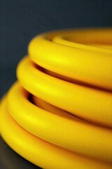 Close-up view of a bright yellow electrical wire, coiled and ready for use The texture and color are vividly displayed, perfect for illustrating electrical work or DIY projects , repair, wire