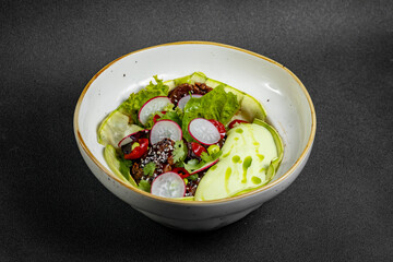 Fresh vegetable salad of green lettuce, radish and cucumber with dill, green onions and greek yogurt