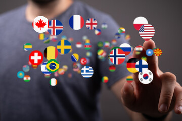 Diverse flags float around a person's hand, symbolizing global connection and communication.
