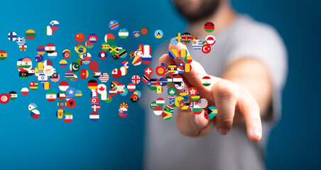 Person interacting with a digital display of world flags, symbolizing global connection and...