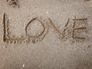 Love drawn on sand beach
