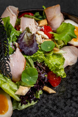 Plate of Fresh Green Salad with turkey ham, mozzarella and tomato isolated on white background