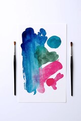 Artistic Canvas with Paint Brushes: A vibrant display of watercolor art comes to life. Two paint brushes stand ready, inviting the viewer to explore a world of creative expression.