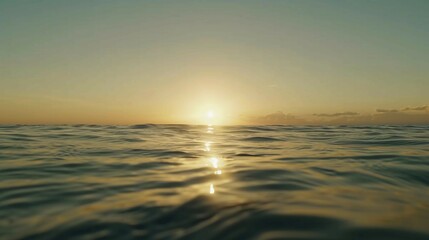 Obraz premium Tranquil ocean view with calm waves under golden sunset, minimalist seascape with copy space, conveying peace, relaxation and freedom of coastal life.