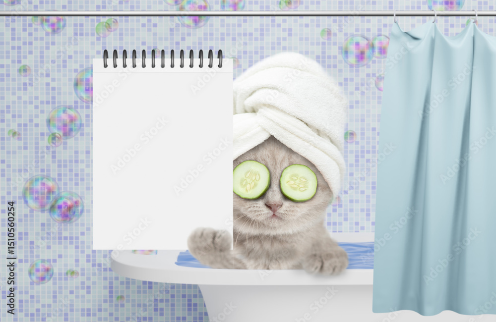 Fototapete funny kitten with towel on it head and slices of cucumber on it eyes takes the bath at home and show