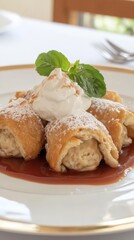 Exquisite Dessert Presentation: Pastry Rolls Topped with Cream and Mint, Drizzled with Sauce and Sprinkled with Sugar for a Sweet Culinary Delight