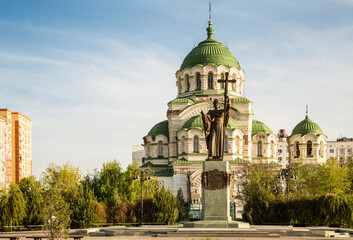 Monument to the Holy Prince Vladimir against the backdrop of the Vladimir Cathedral in Astrakhan. Russia