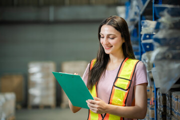 Empowered woman working in warehouse with technology. Symbol of women in logistics and industrial...