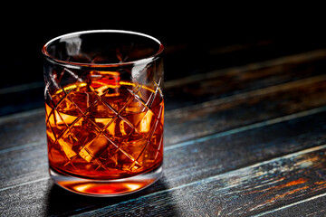 A glass of whiskey with ice stands on an old wooden table. 3D rendering.