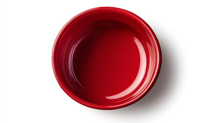 Red plastic bowl on a white background, top view. Close-up of a red, round food container for a dog or cat pet with no text