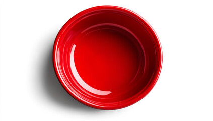 Red plastic bowl on a white background, top view. Close-up of a red, round food container for a dog or cat pet with no text