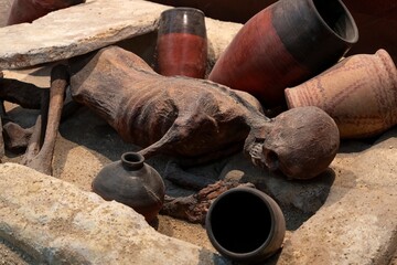 Recreation of an ancient Egyptian burial site with canopic jars, which were containers used to store the internal organs of the deceased during the mummification process