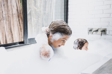Latin children girls bathing at home in Mexico Latin America, hispanic kids