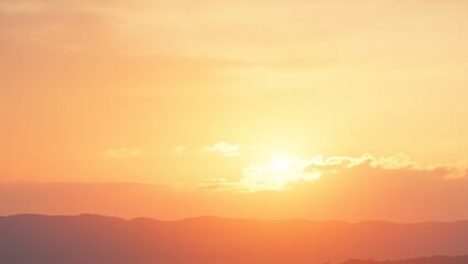 Spectacular sunset view over mountain ranges bathed in warm golden hour sunlight.