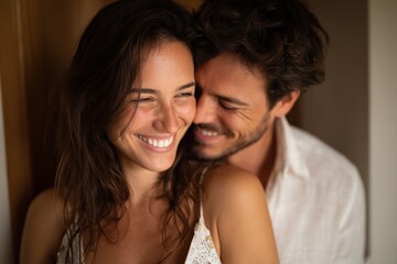 Happy couple sharing a joyful moment at home, embracing and smiling together. 