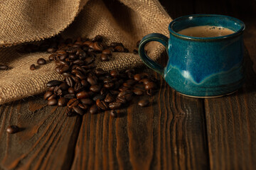 Coffee cup with espresso and roasted coffee beans.