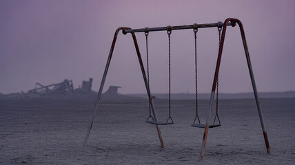 Abandoned Rusty Swingset on a Desolate Landscape under a Purple Sky at Dusk