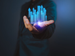 Businessman analyzes company profit, on technical chart positive indicator arrow pointing up, stock market analysis, technology investment of financial information for long term investment.