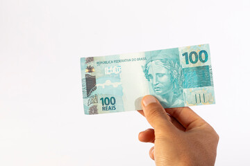 Hands of a Man Holding 100 Brazilian Bank Notes Reais