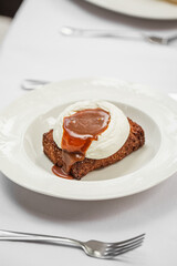 Portion of gourmet chocolate brownie dessert with syrup