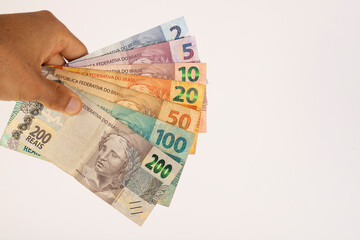 Hands of a Man Holding Brazilian Bank Notes Reais ready to pay