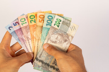 Hands of a Man Holding Brazilian Bank Notes Reais ready to pay