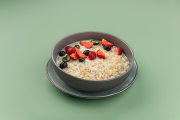 Portion of sweet breakfast oatmeal porridge with berries