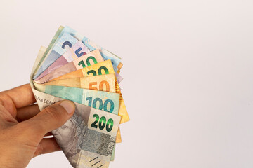 Hands of a Man Holding Brazilian Bank Notes Reais ready to pay