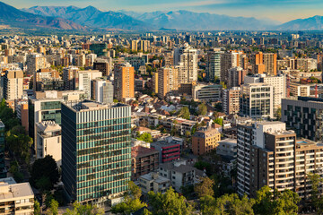 From an elevated vantage point, the Providencia district of Santiago de Chile unfolds at sunset,...