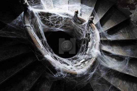 Spiral staircase wrapped in spiderwebs