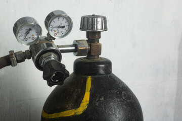 Cylinder with reducer reducing gas pressure. Carbon dioxide in a cylinder for welding metals.