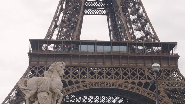 View of the wrought-iron lattice Eiffel Tower from the Pont d'Iena bridge in the 7th arrondissement of Paris, France.