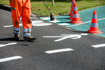 Road workers marking cycle paths