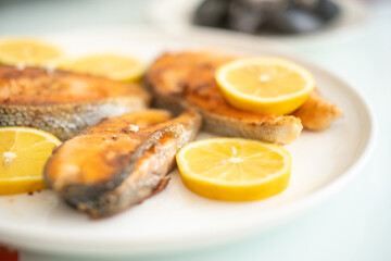 fried salmon fish with lemon plate close up