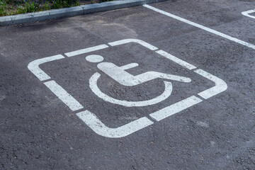 Parking spaces with the disabled pictogram and markings on the asphalt
