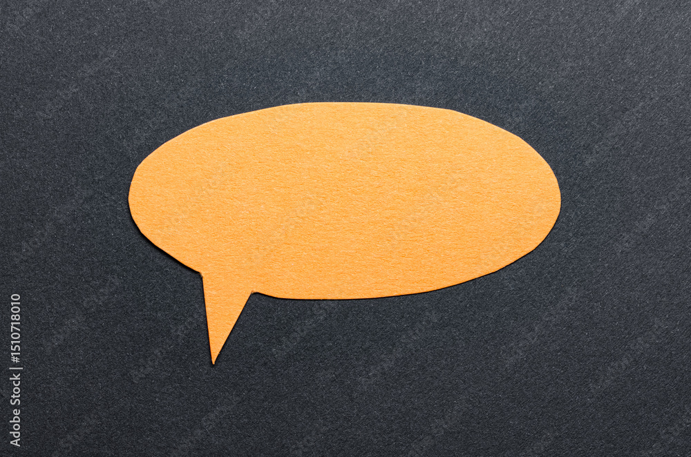 Poster orange cut out blank paper speech bubble of round shape with copy space for text on dark background,