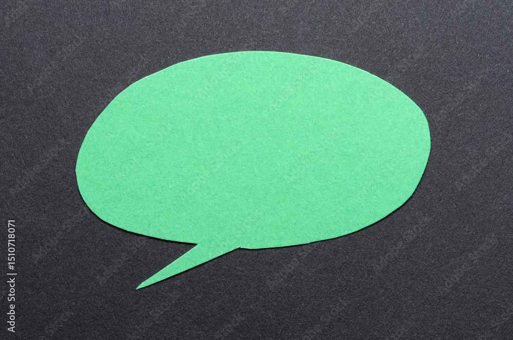 Poster green cut out blank paper speech bubble of round shape with copy space for text on dark background, 
