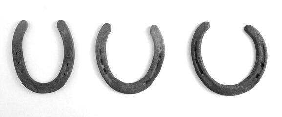 Rusty horseshoes for western banner in black and white.