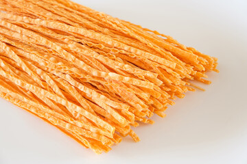 dried fish straws on white background, selective focus