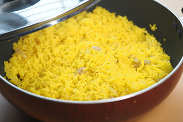 Delicious yellow rice cooked in a large pot for dinner