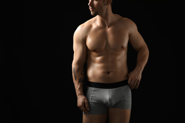 Fototapeta premium Young man in stylish light grey underwear on black background, closeup