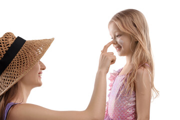 Smiling mother applying sun protection product onto her daughter's nose on white background