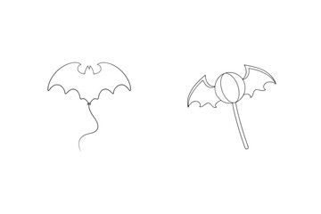Two halloween themed designs featuring a bat shaped balloon and a bat wing lollipop isolated
