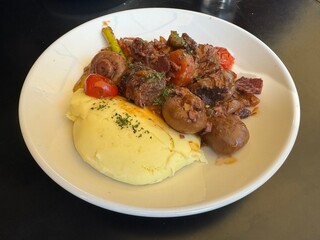 Braised beef stew with vegetables and mashed potato