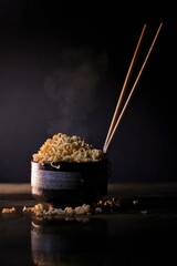 Steaming hot instant noodles in a dark ceramic bowl with chopsticks, set against a moody, dimly lit...