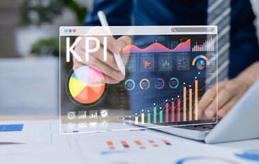 Businessman analyzing key performance indicators KPI with various graphs and charts with digital screen to show data analysis and performance tracking. Key Performance Indicators Analysis
