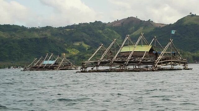 Bagan Apung or bagang is a traditional fishing structure made of bamboo for cathing anchovy in the middle of the sea. Beautiful scenery of traditional floating hut for sea fishing on the sea of Lombok