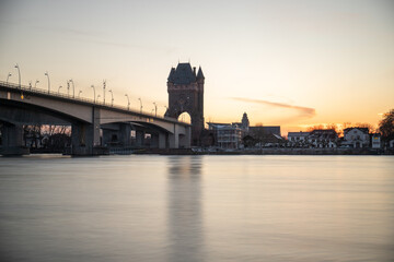 A road or highway leads through an old historic city gate. Sunset in the evening over the Rhine...