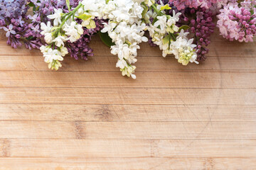 lilac flower arrangement on old board background with free space